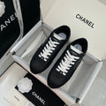 Chanel unisex black leather sneakers with white laces and logo patch