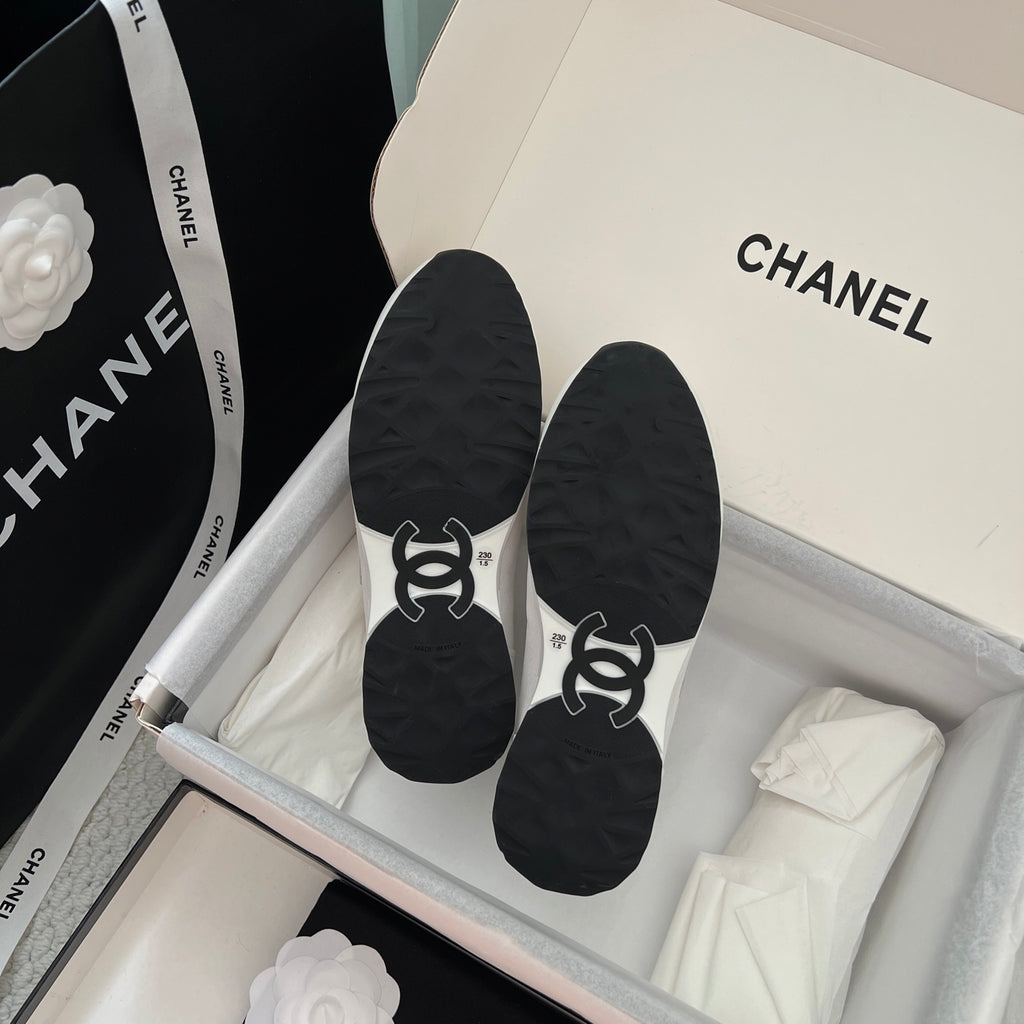 Black sneaker outsoles with Chanel CC logo design.