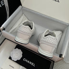 White Chanel unisex sneakers from the back with padded heel and lace-up front.