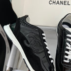 Black Chanel unisex sneaker close-up with textured side and white laces