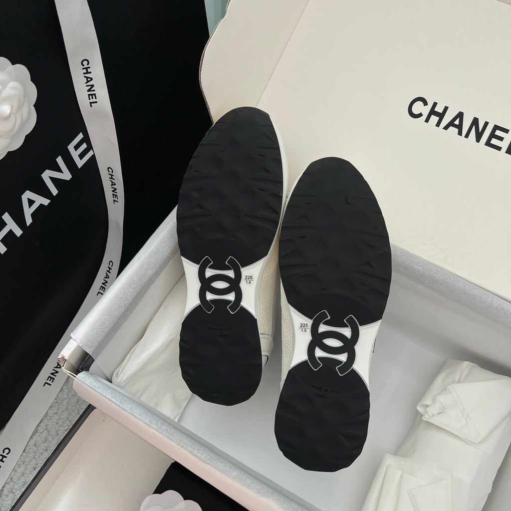 Black sneaker soles with traction tread and logo embossing