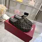 Gucci slide sandals in dark GG monogram fabric with gold horsebit detail, black sole.