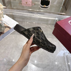 Gucci ankle-height slide bootie style in dark GG monogram fabric with gold horsebit detail.