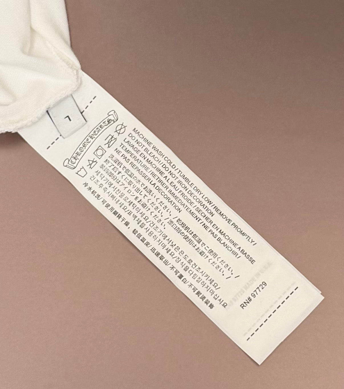 White T-shirt with visible care label and size tag at the inner hem