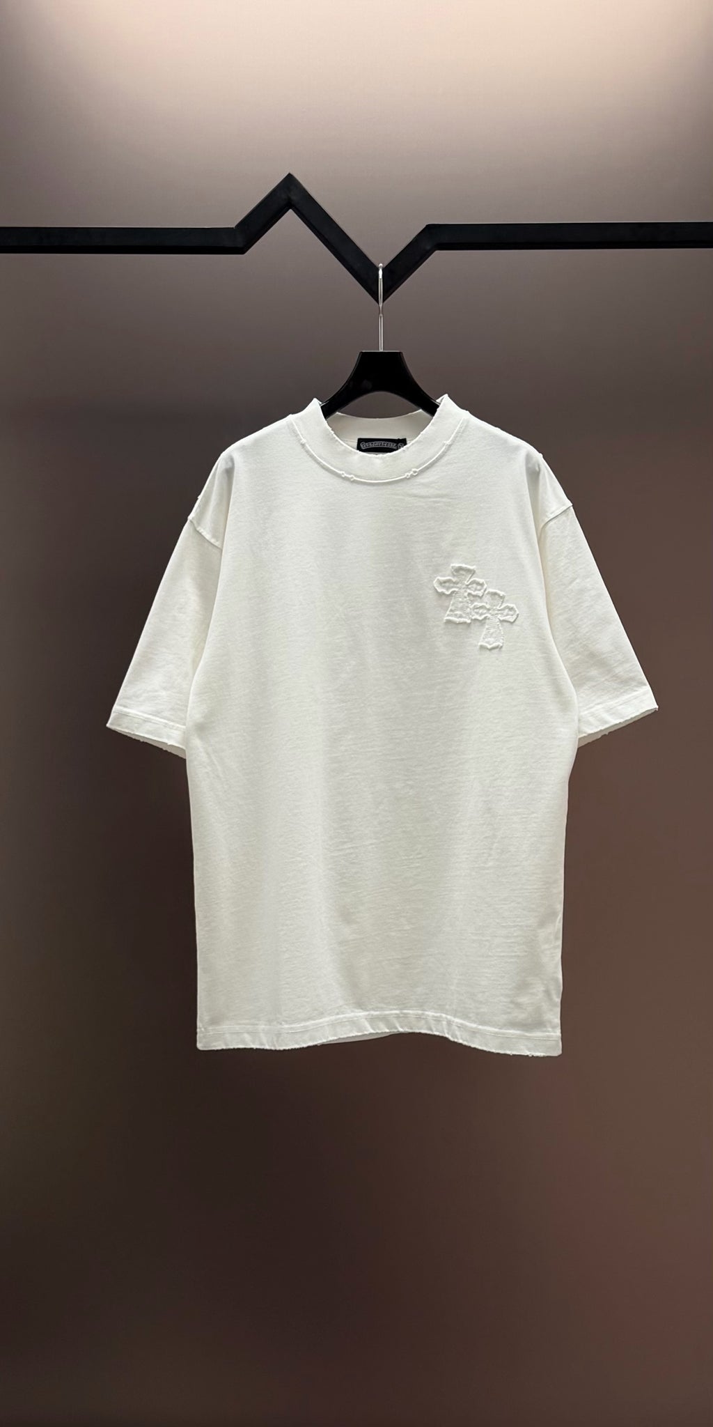 White crew-neck short-sleeve T-shirt with small embroidered chest graphic