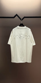 White crew-neck short-sleeve T-shirt with larger embroidered back graphic
