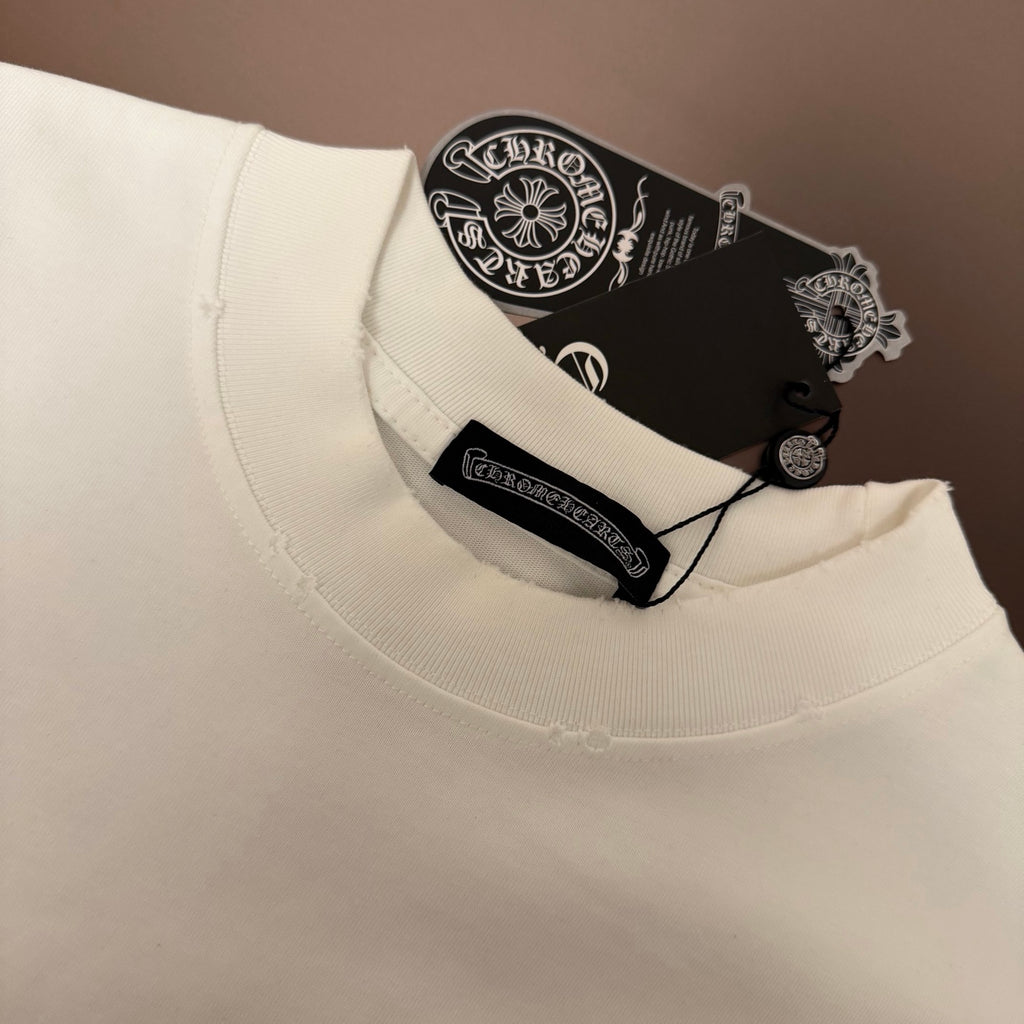 White crew-neck T-shirt collar with black brand tag on the inside neckline