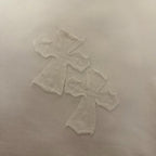White T-shirt chest graphic with raised embroidered cross pattern