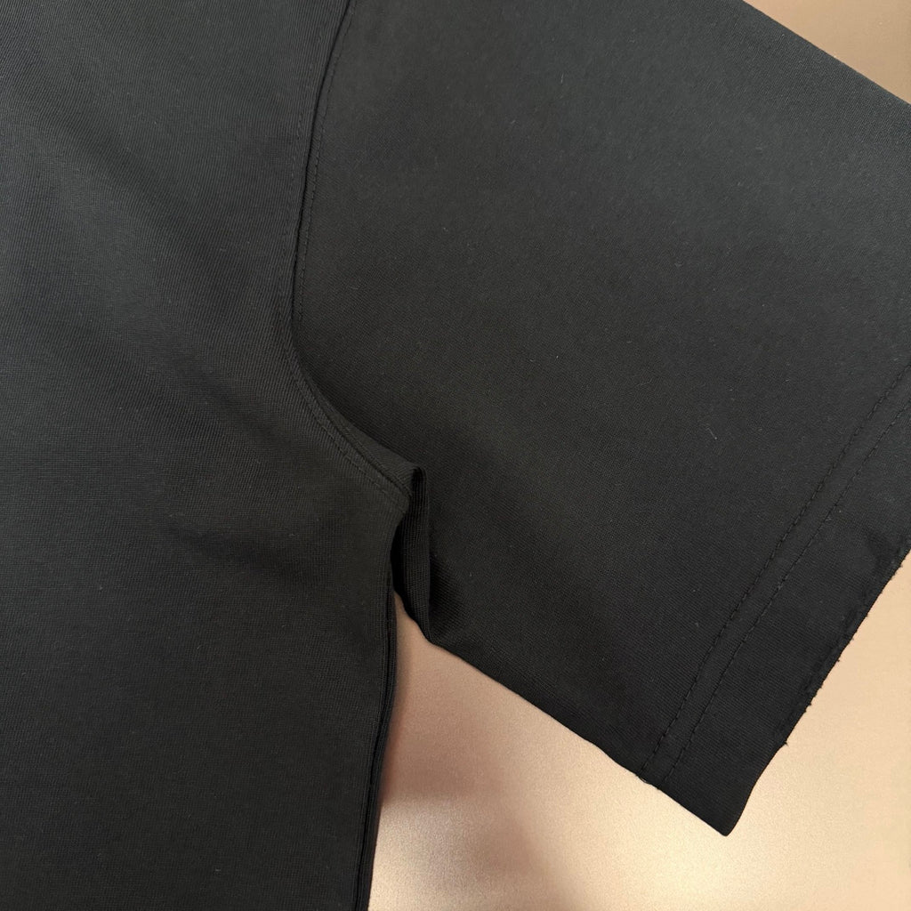 Black short-sleeve T-shirt hem with side seam and stitched edge