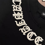Black T-shirt close-up of white graphic lettering along the chest
