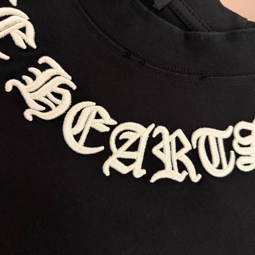 Black T-shirt with large white stylized lettering across the chest
