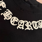 Black T-shirt with large white stylized lettering across the chest