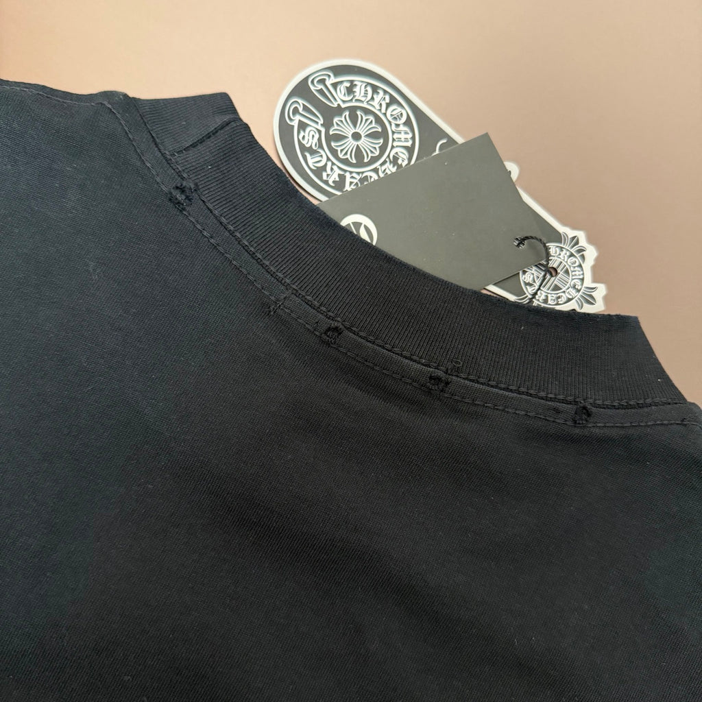 Black T-shirt neckline with ribbed collar and small snap detail