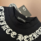 Black crew-neck T-shirt collar with white logo embroidery and neck tag