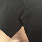 Black short-sleeve T-shirt sleeve and side seam with stitched hem detail