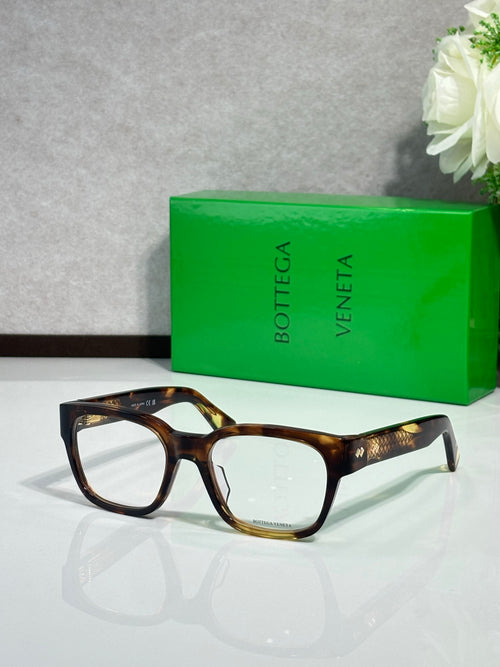 Tortoiseshell eyeglasses with rectangular frames and gold-toned temple details