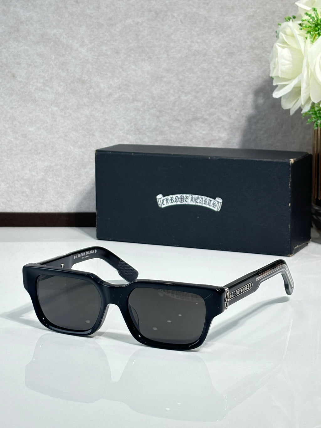 Black rectangular eyeglasses with dark lenses and metal temple detailing