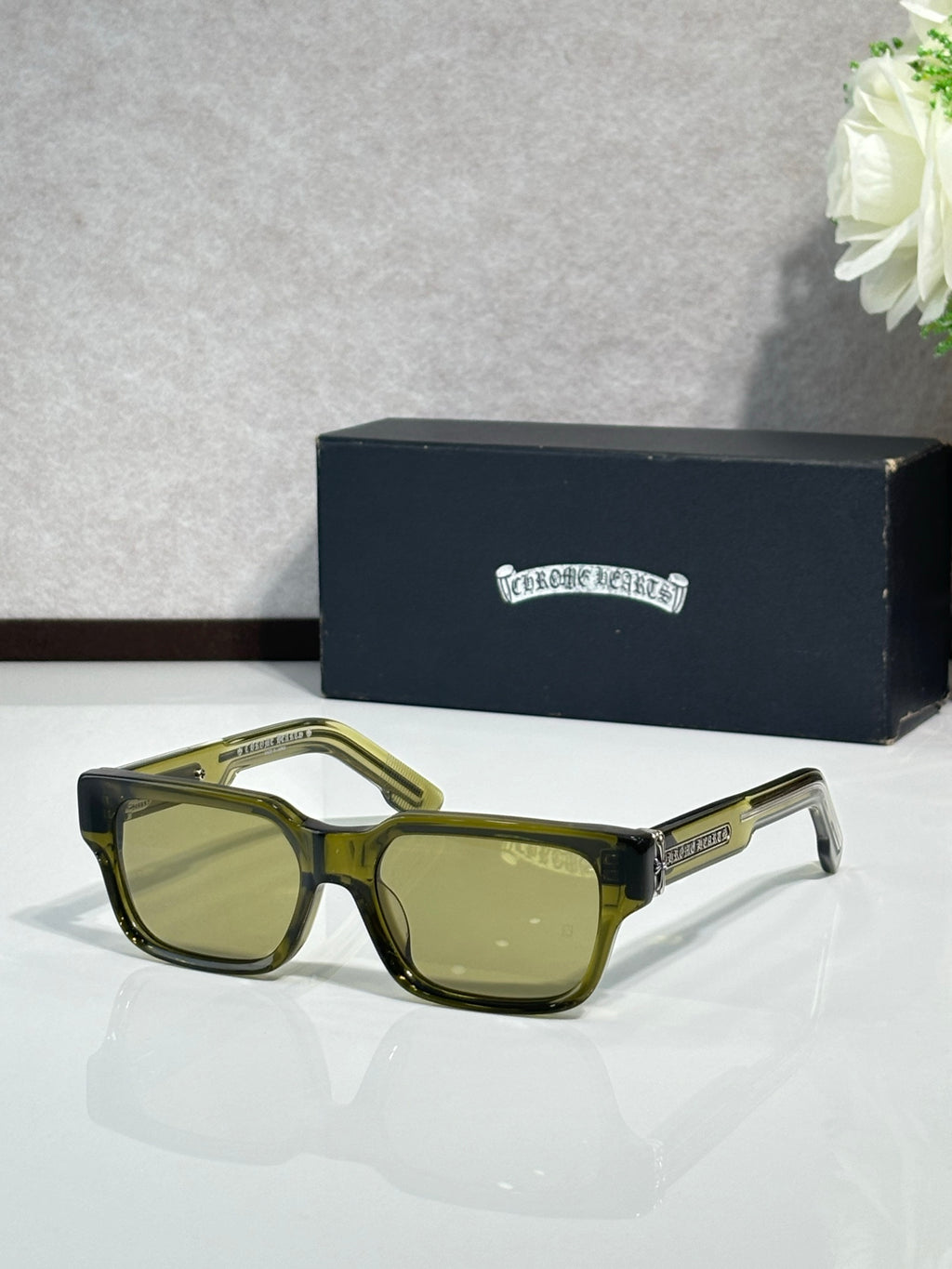 Olive green rectangular eyeglasses with green-tinted lenses and metal temple detailing
