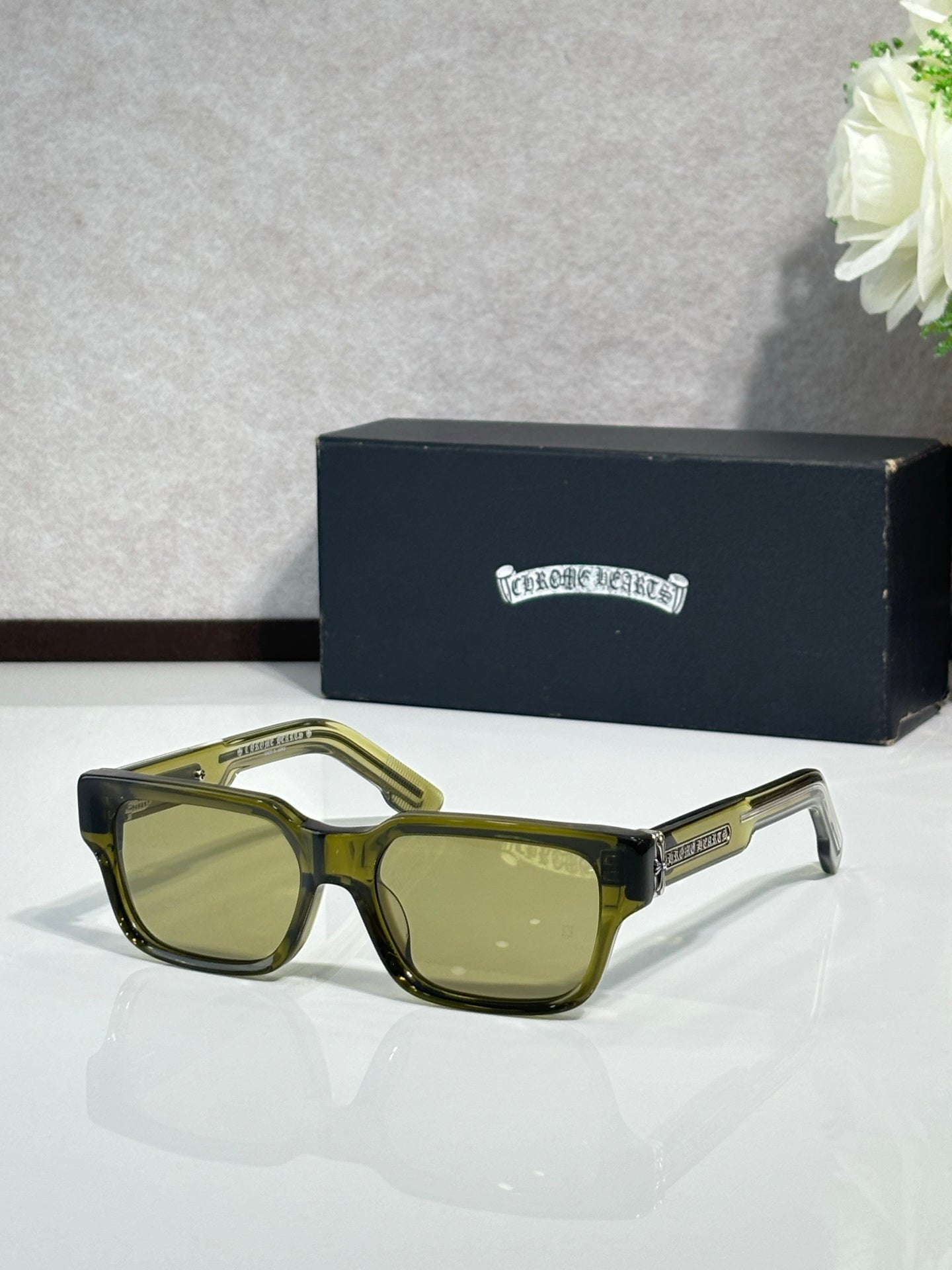 Olive green rectangular eyeglasses with green-tinted lenses and metal temple detailing