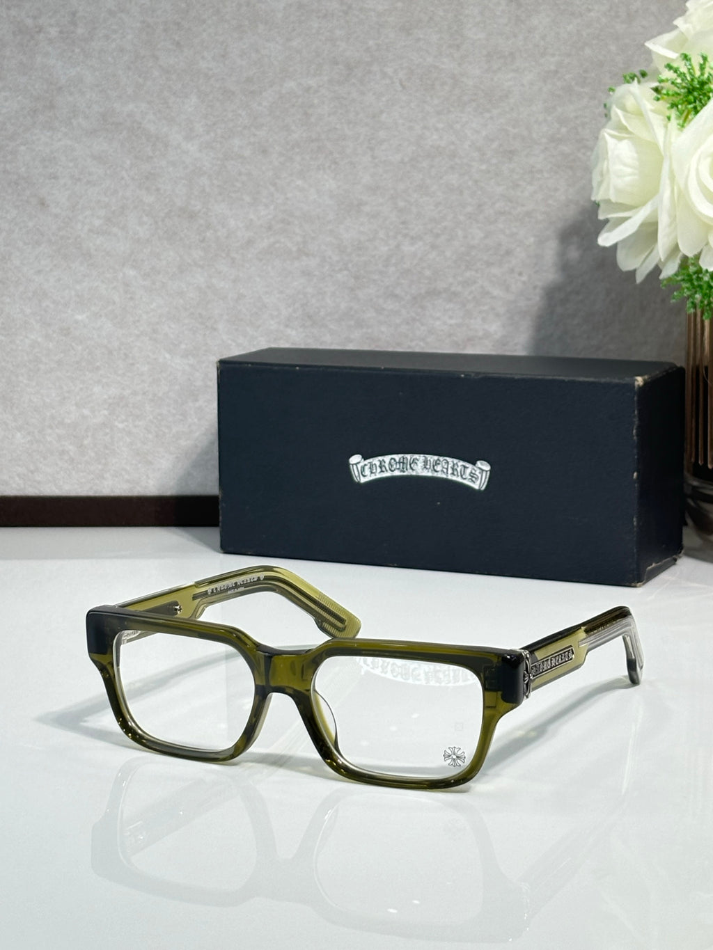 Olive green rectangular eyeglasses with clear lenses and metal temple detailing
