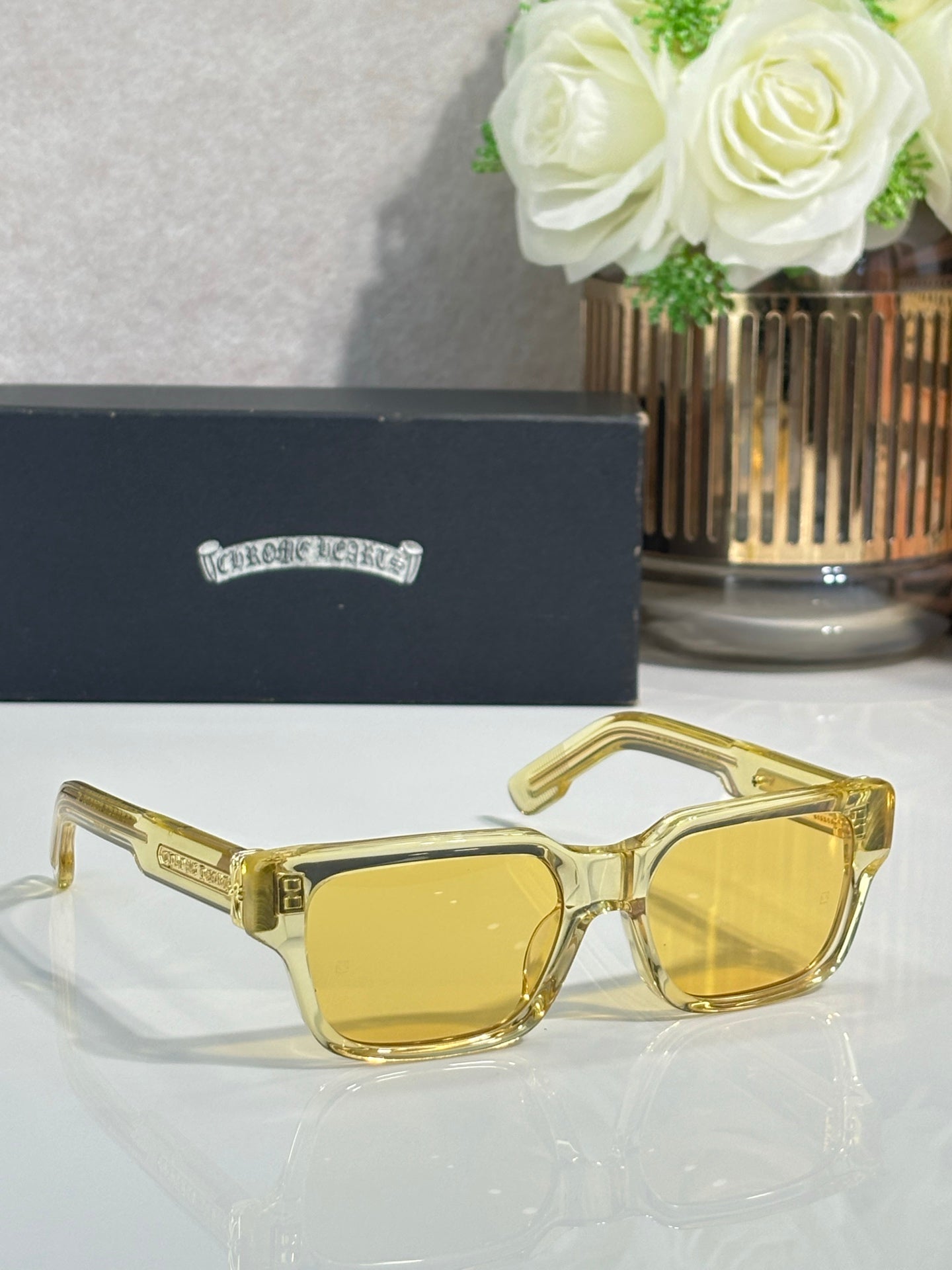 Chrome glasses with gold frame and amber-tinted lenses