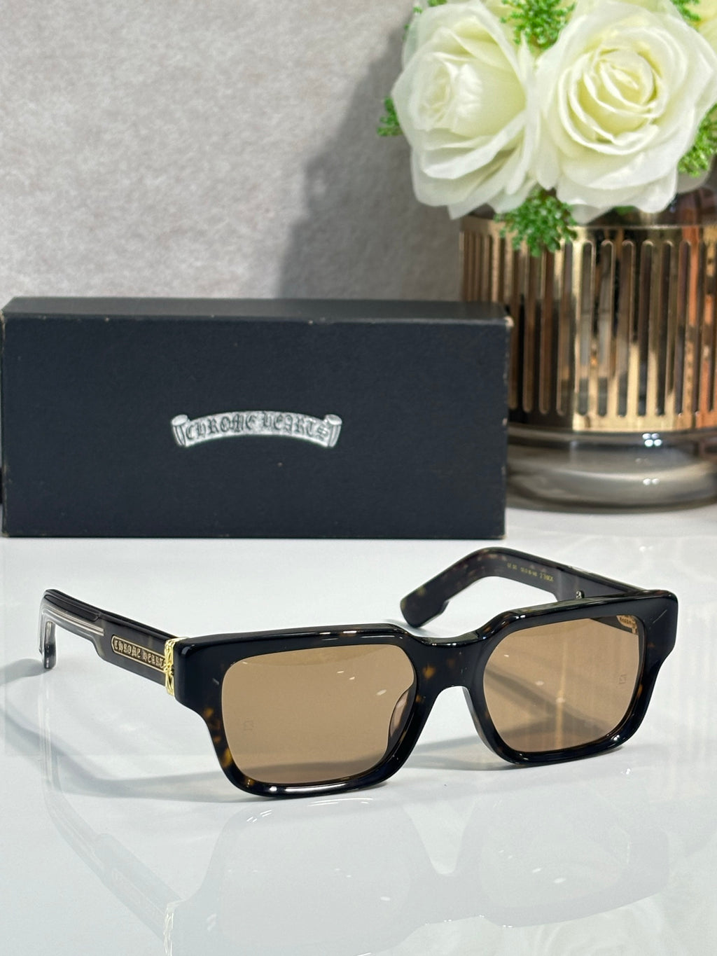 Chrome glasses with dark frame and tan-tinted lenses