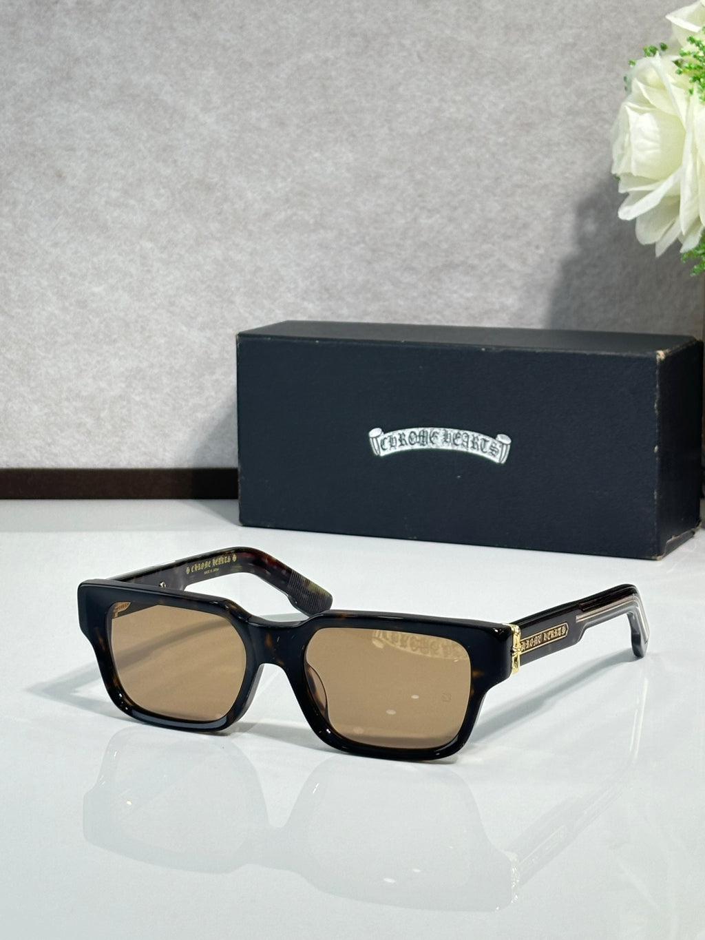 Chrome glasses with black frame and tan-tinted lenses