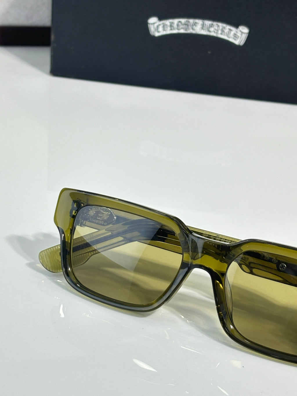 Chrome glasses with olive-gold frame and yellow tinted lenses