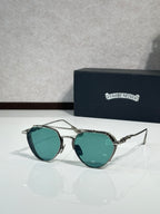Chrome glasses with teal-tinted lenses and metal frame, round oversized shape