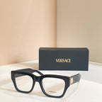 Eyeglasses frame with dark rectangular front and clear lenses, paired with Versace logo box
