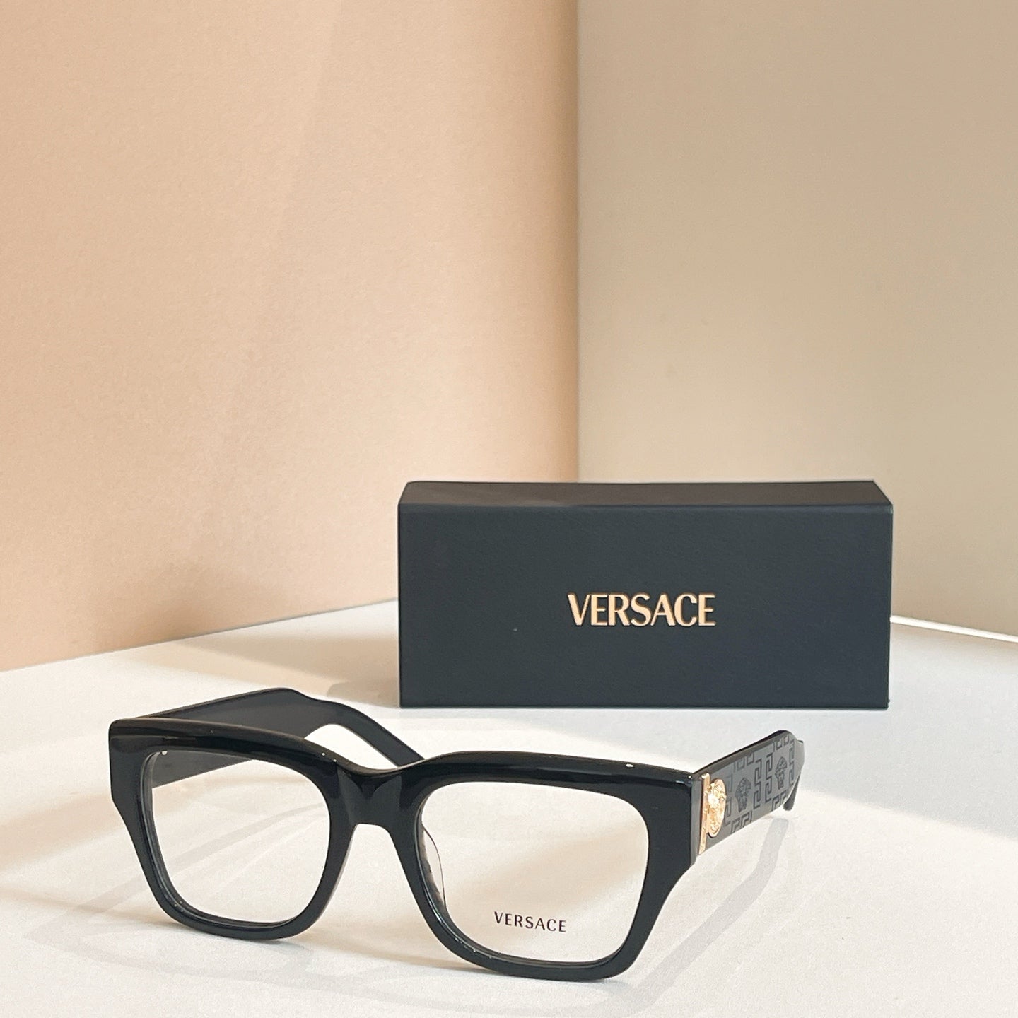 Eyeglasses frame with dark rectangular acetate and clear lenses, with Versace logo box
