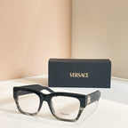 Versace eyeglasses frame in dark acetate with clear lenses, shown with logo box