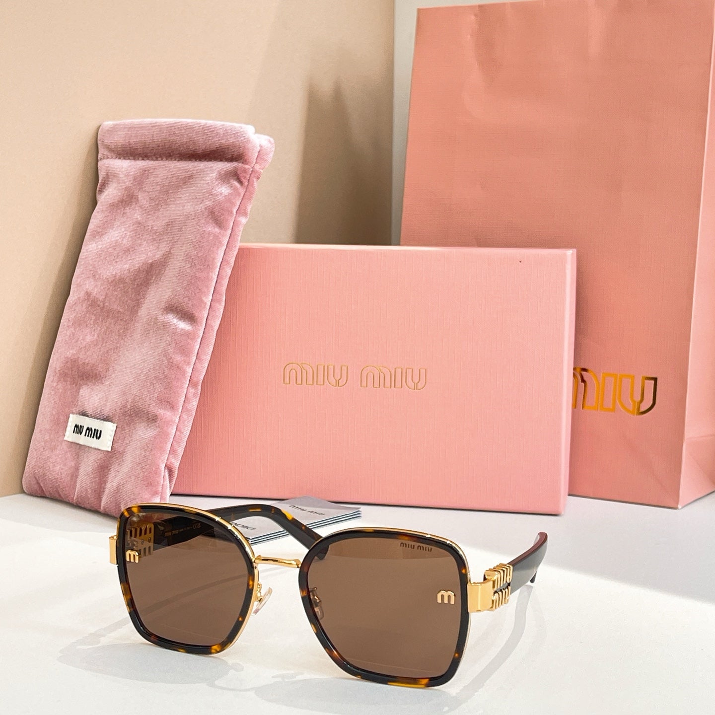 MiuMiu square sunglasses with tortoiseshell accents and dark brown tinted lenses