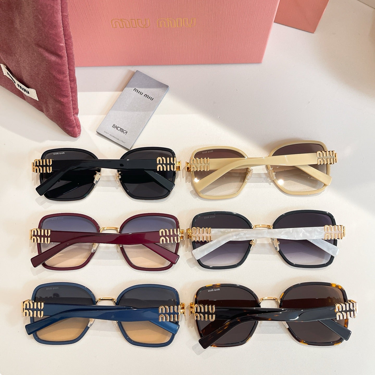 Set of MiuMiu sunglasses with multiple frames and tinted lenses, plus pouch