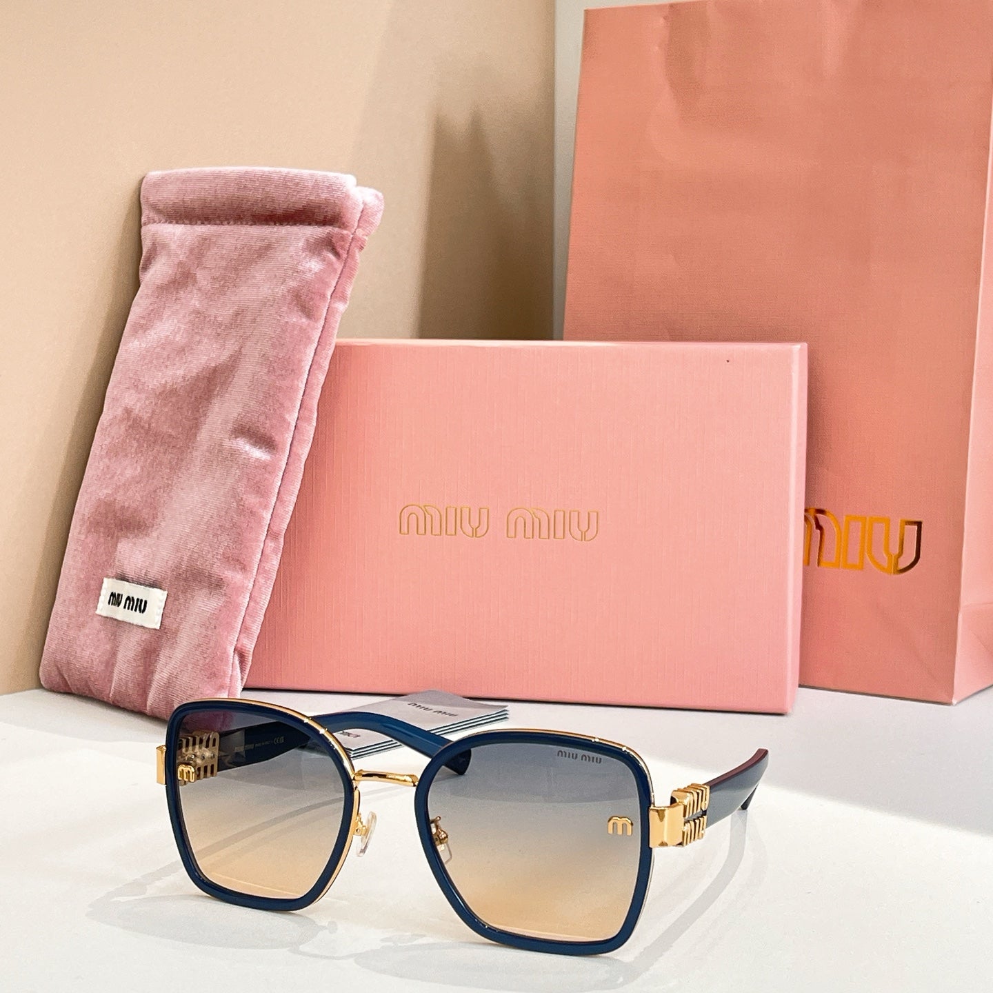 MiuMiu square sunglasses with navy frame and light tan tinted lenses