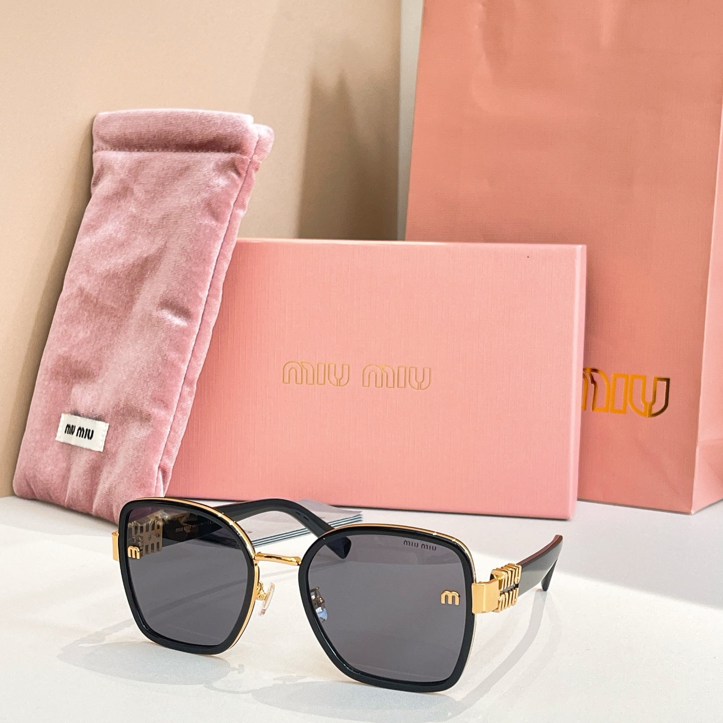 MiuMiu square sunglasses with black frame and gray tinted lenses