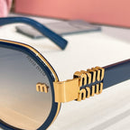 MiuMiu gold-tone logo hinge detail on blue round sunglasses