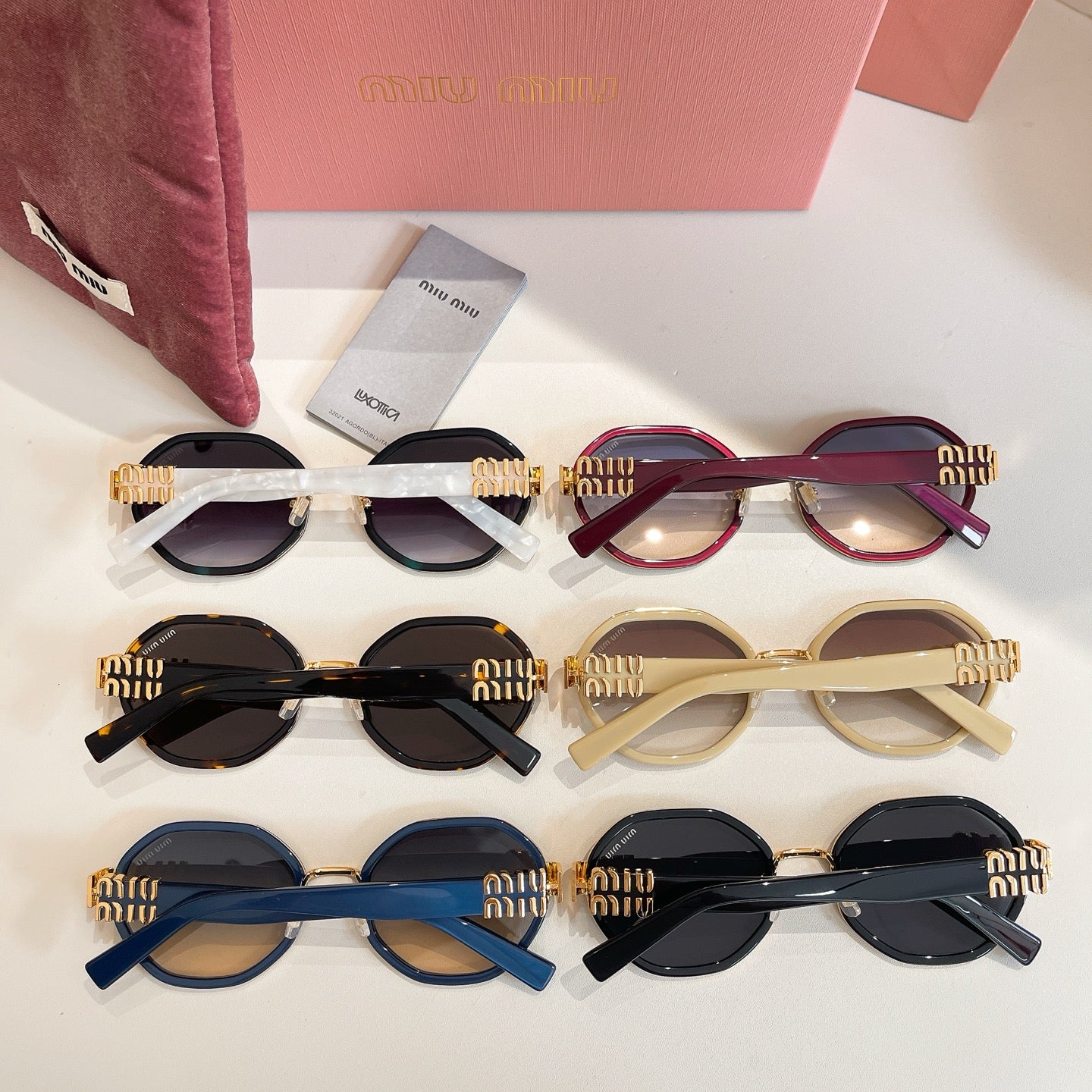 MiuMiu sunglasses set with assorted frame colors in a neat row