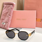 MiuMiu round sunglasses with black frames and gold-tone logo arms