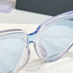 Balenciaga sunglasses close-up with clear frames and light lenses, curved temple detail