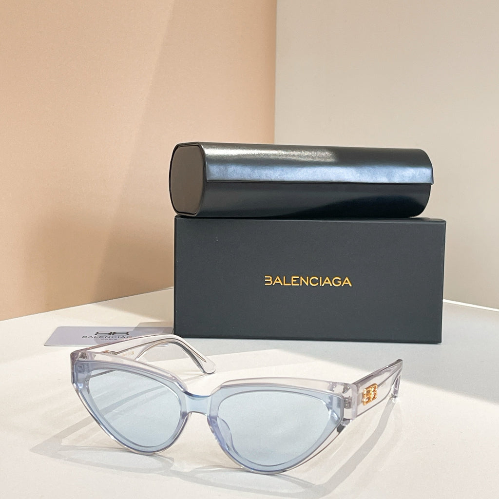 Balenciaga sunglasses with clear light-blue frames and light lenses, gold logo temple
