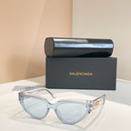 Balenciaga sunglasses with clear light-blue frames and light lenses, gold logo temple