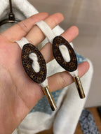Faux leather zip pulls with gold hardware on blue monogram lining