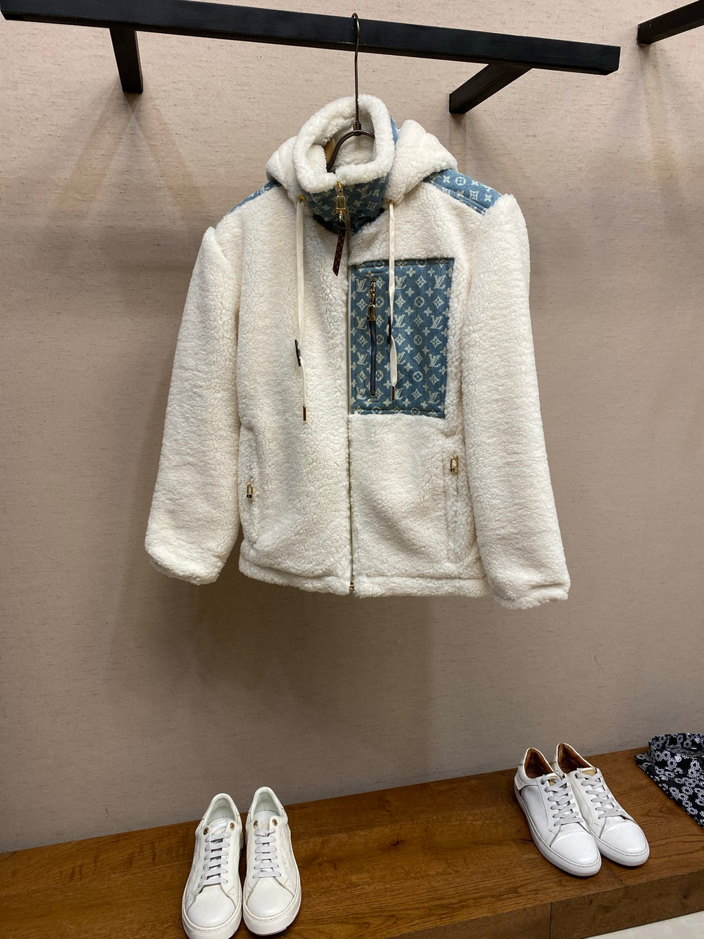 White sherpa hooded jacket with blue monogram panel and front pockets