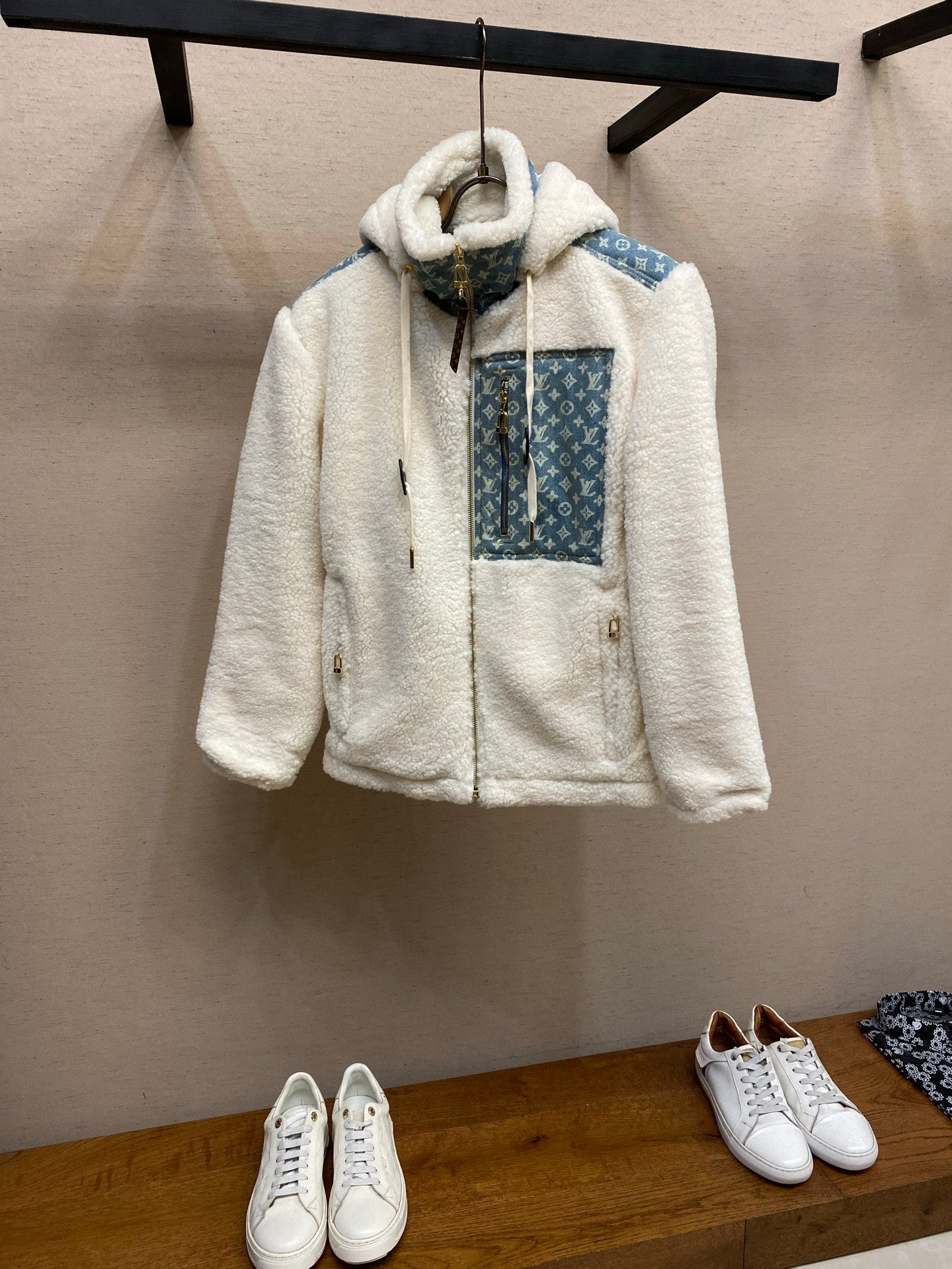 White sherpa hooded jacket with blue monogram panel and front pockets