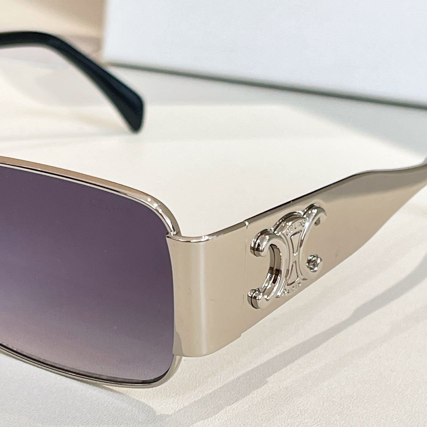 Square sunglasses with purple tinted lenses and silver metal arms