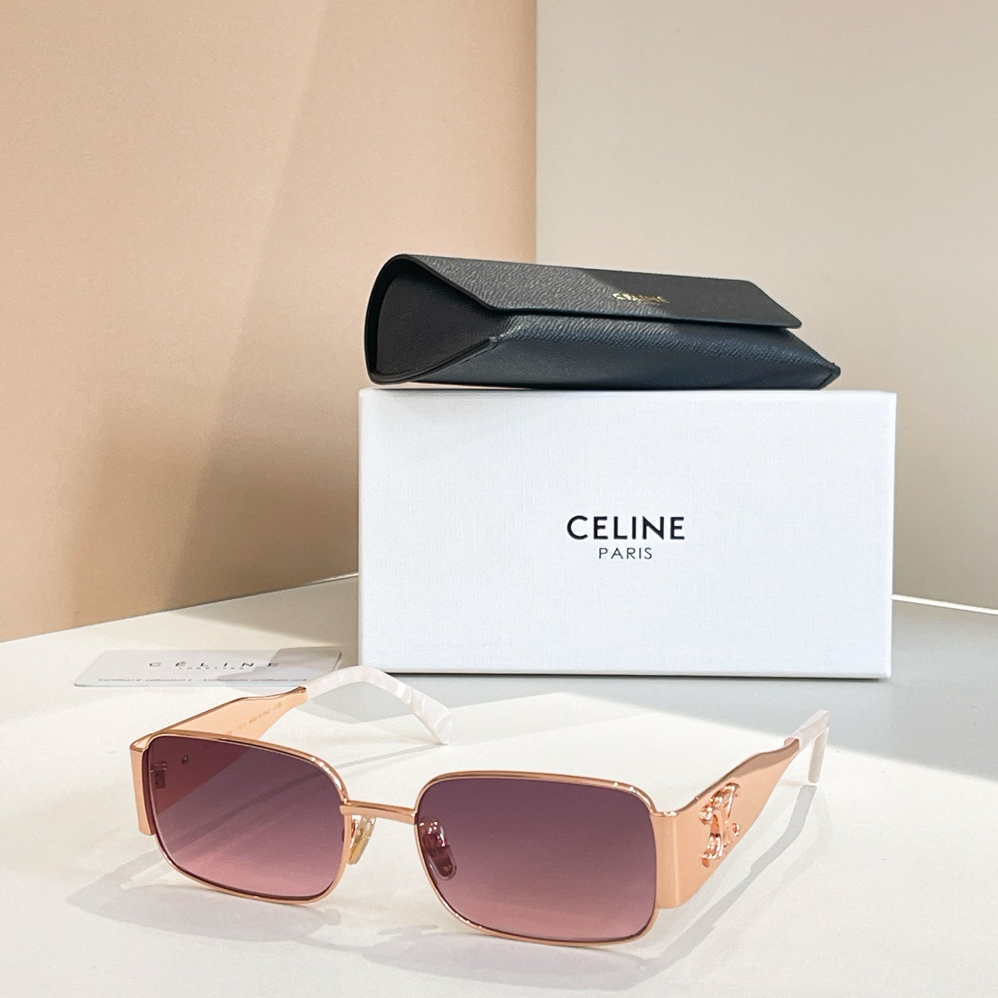 Sunglasses with pink lenses and gold square frames