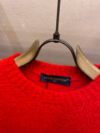 Red knit sweater neckline with Louis Vuitton brand tag