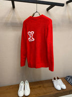 Red knit sweater with white Louis Vuitton monogram logo on the back