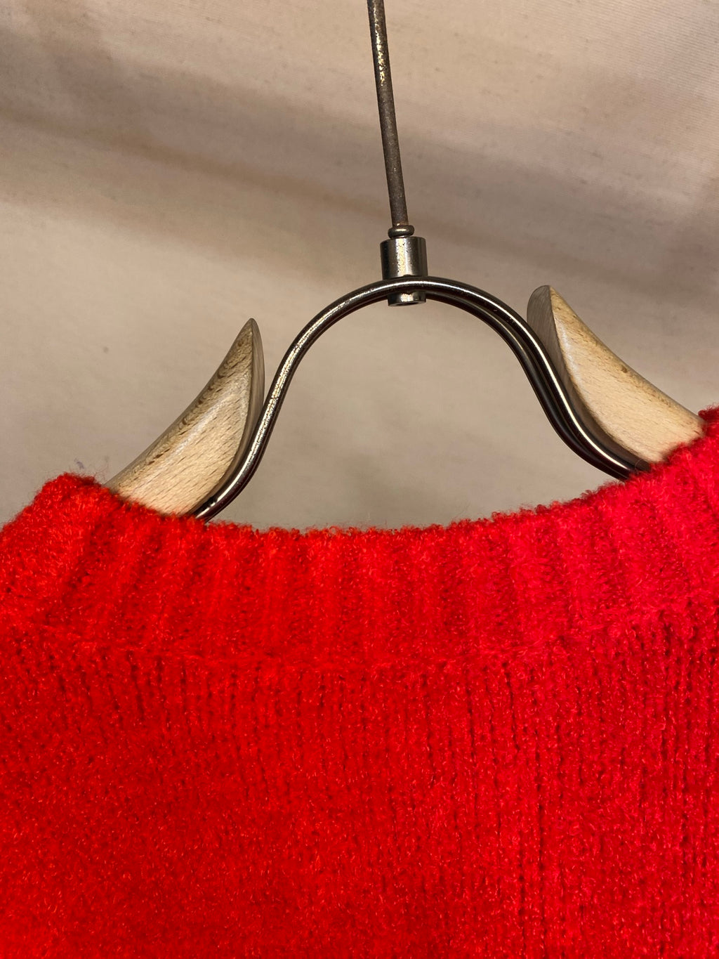 Red knit sweater back with ribbed neckline and hem